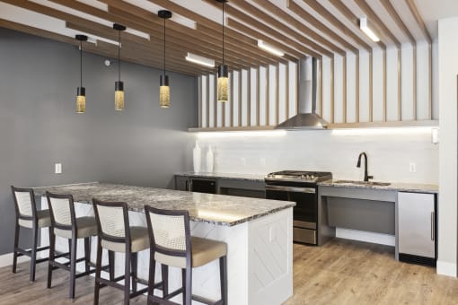 a kitchen with a large island and a stove top oven