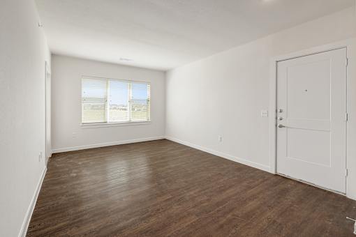 A room with wooden floors and white walls.