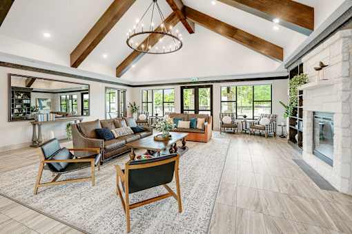 A modern living room with a fireplace and a large rug.