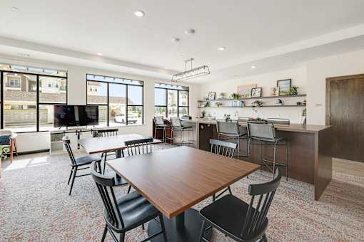 A modern dining room with a large table and chairs.
