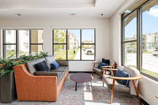 A living room with a large window overlooking a street.