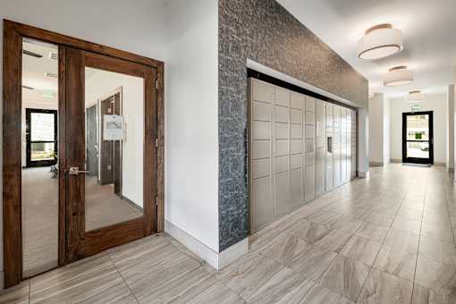 A hallway with a tiled floor and a wall with a stone pattern.