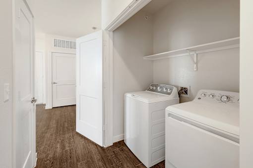 A small laundry room with a washer and dryer.