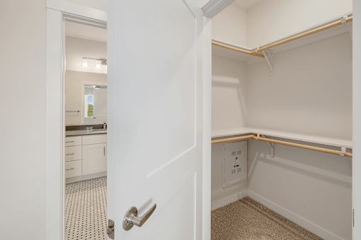 A white door with a silver handle is open.