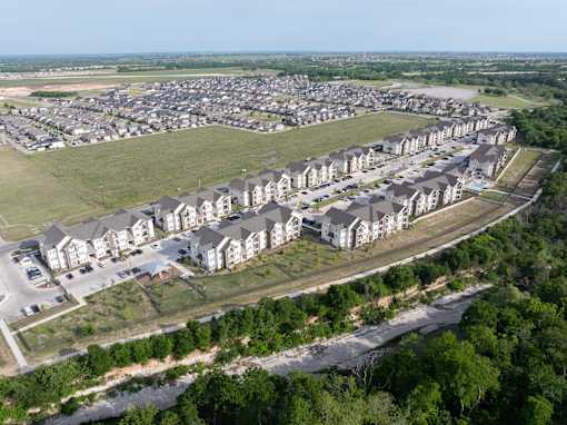 A bird's eye view of a residential area with houses and a river.