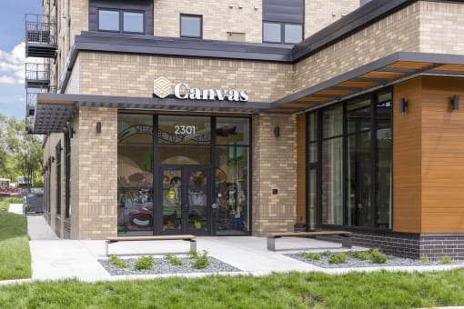 the front of a canvas building with a glass door