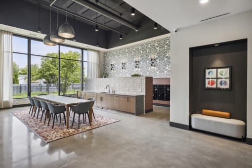 a dining room and kitchen area with a table and chairs and a large window