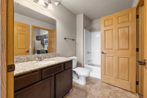 the ensuite bathroom at the enclave at woodbridge apartments in sugar land, tx