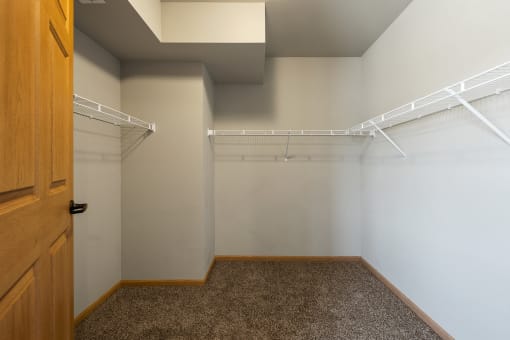 a spacious walk in closet in the master bedroom