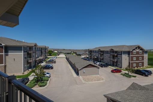 an aerial view of an apartment complex with a blue sky in the background