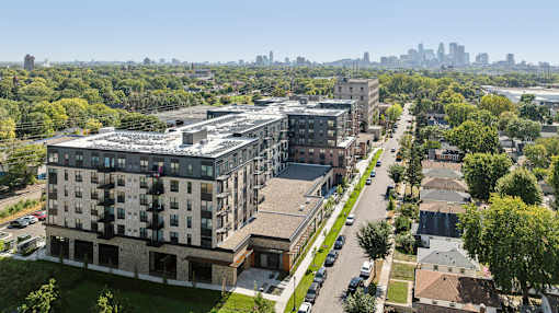 A large building with a lot of windows is surrounded by trees.