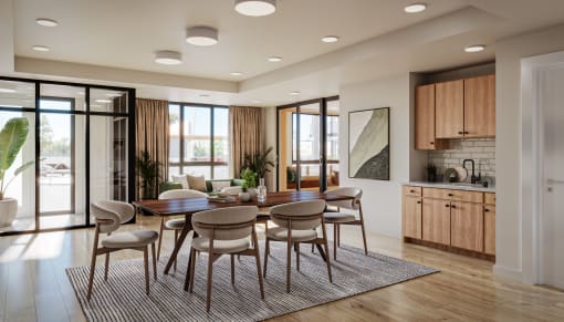 a dining area with a wooden table and chairs and a kitchen in the background