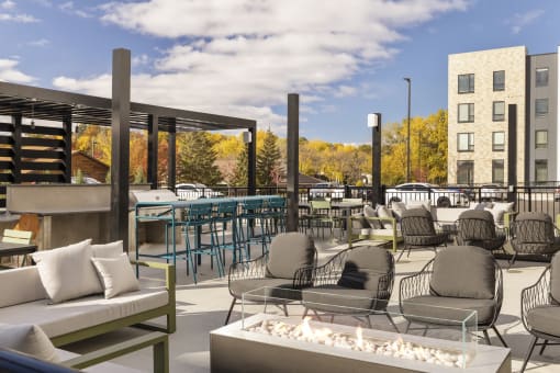 outdoor fireplace and lounge area at savor apartments