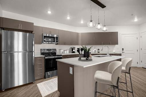 A modern kitchen with a stainless steel refrigerator and white countertops.