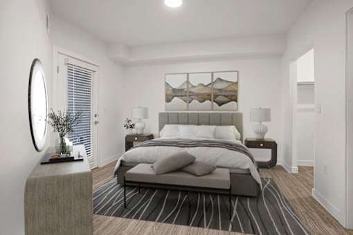 A modern bedroom with a large bed and a round mirror on the wall.