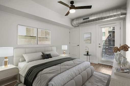 A bedroom with a large bed and a ceiling fan.