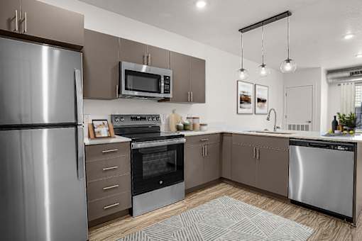 A modern kitchen with stainless steel appliances and wooden cabinets.