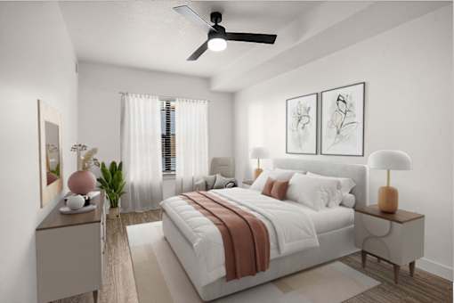A bedroom with a bed, nightstands, and a ceiling fan.