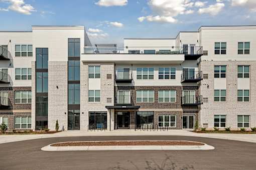 A modern building with a courtyard in front.