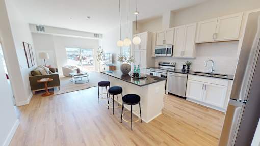 A kitchen with a bar stool and a counter.