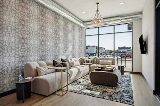 A living room with a large couch and a coffee table.