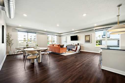 A modern living room with a white dining table and chairs.