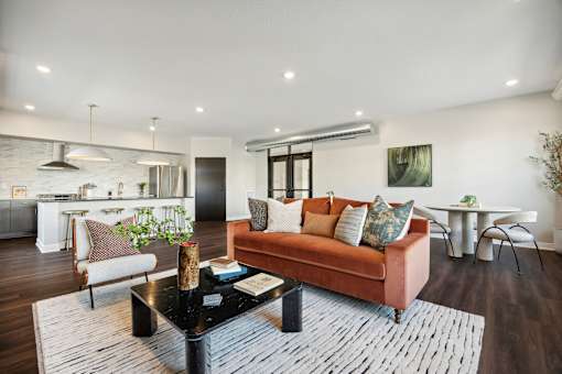A living room with a brown couch and a black coffee table.