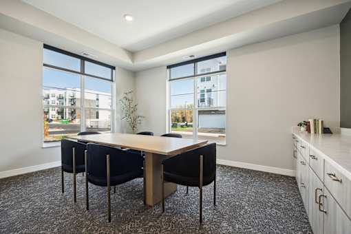 A conference room with a long table and chairs.