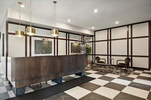 A black and white checkered floor in a room with a long wooden bench.