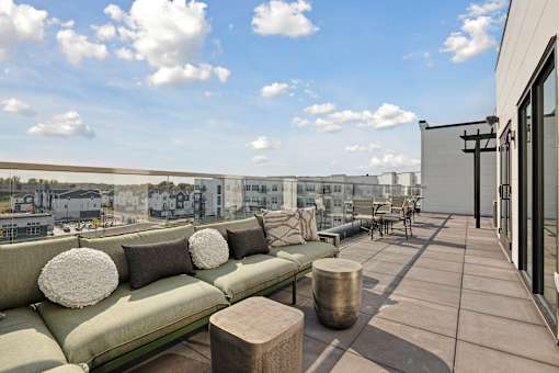 A patio with a couch and pillows is shown.