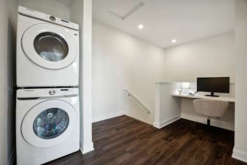 A white washing machine and dryer in a laundry room.