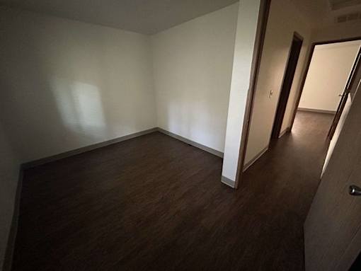 A room with wooden floors and white walls.