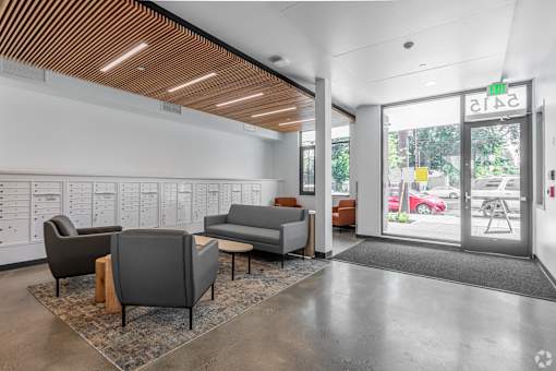 A waiting area with a couch, chairs, and a coffee table.
