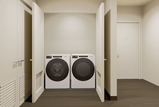 Two front loading washing machines in a laundry room.