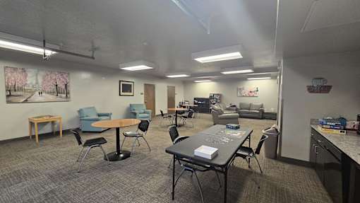 A room with a table and chairs in it.
