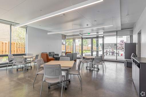 A conference room with a long table and chairs.