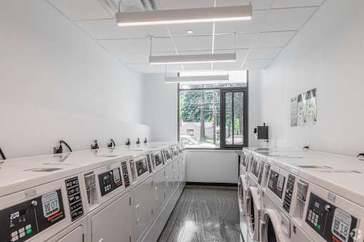 A row of washing machines in a laundromat.