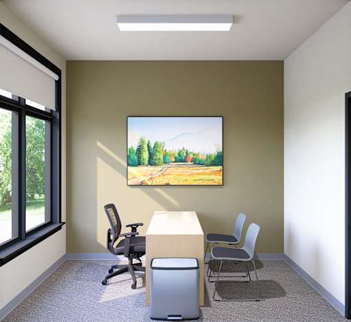 A room with a painting of a forest on the wall and a desk with chairs.