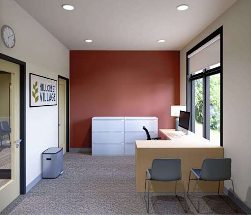 A room with a white desk and two chairs.