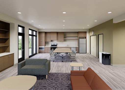 A modern living room with a dining area and kitchen in the background.