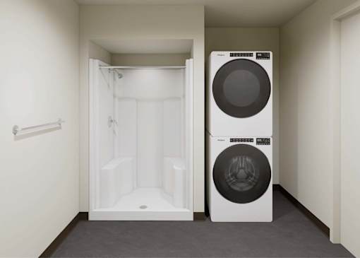 A white washing machine is in a small laundry room.