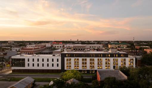 A modern building with a lot of windows is shown in the image at Miles at Ybor Apartments, Tampa