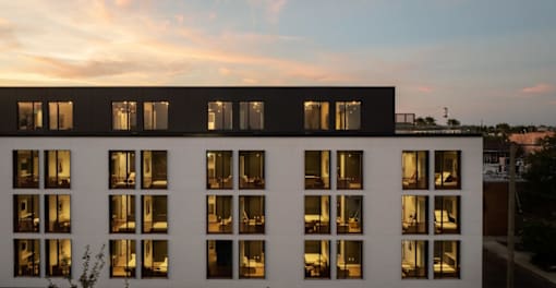 A building with a lot of windows is shown in the image at Miles at Ybor Apartments, Tampa 33605