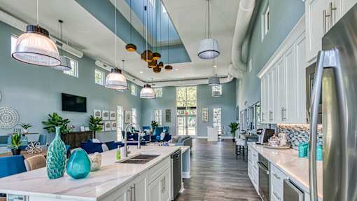 A kitchen with a blue and white color scheme and a large island in the center.