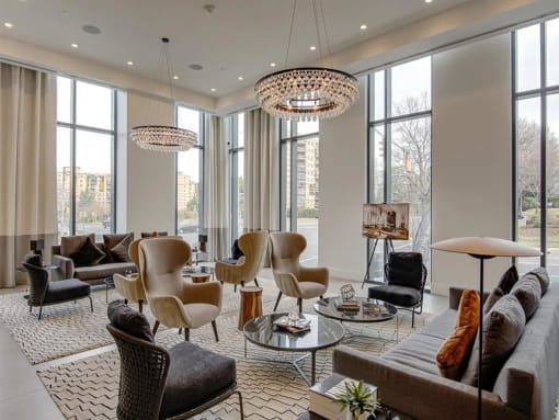 a living room filled with furniture and large windows at The Boro, Tysons, 22102