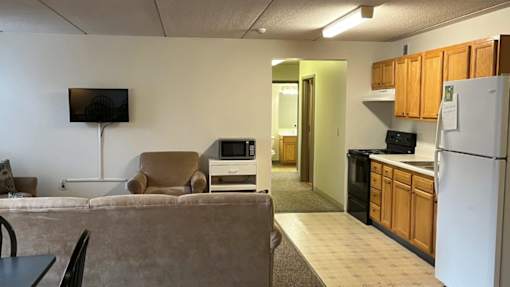 A kitchen area with a refrigerator, microwave, and oven.