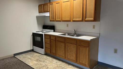 A kitchen with wooden cabinets and a white countertop.