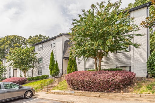 Renovated Exteriors and a green tree at Pinewood Townhomes, Tucker, 30084