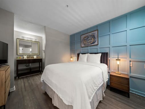 Furnished Bedroom with cozy bed and lamp set at the 505 Collection in Atlanta, Georgia.
