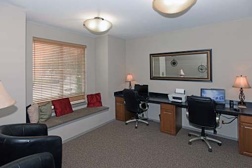 A room with two desks and two chairs.